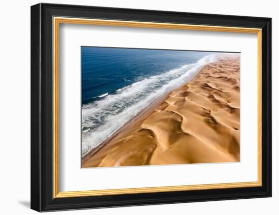 Langewand, Aerial view of where the Atlantic Ocean meets the sea of dunes in Western Namibia.-ClickAlps-Framed Photographic Print