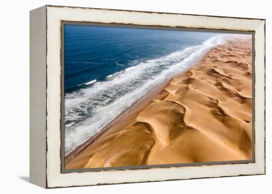 Langewand, Aerial view of where the Atlantic Ocean meets the sea of dunes in Western Namibia.-ClickAlps-Framed Premier Image Canvas