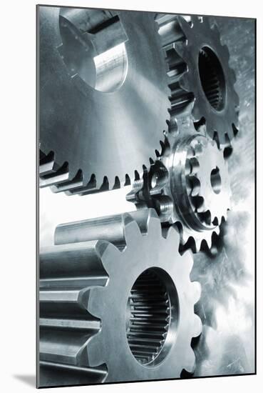 Large Industrial Gears Set Against Titanium And In A Blue Metallic Toning Concept-lagardie-Mounted Art Print