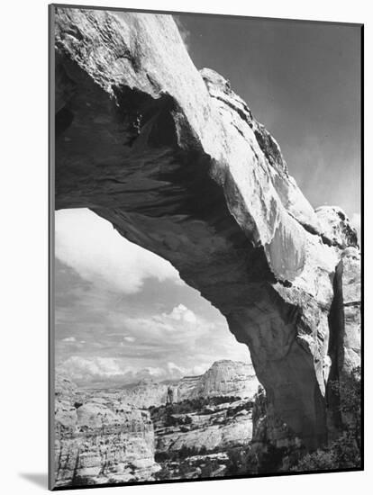 Large Rock Formation Forming a Bridge across Desert-Loomis Dean-Mounted Photographic Print