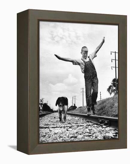 Larry Jim Holm with Dunk, His Spaniel Collie Mix, Walking Rail of Railroad Tracks in Rural Area-Myron Davis-Framed Premier Image Canvas