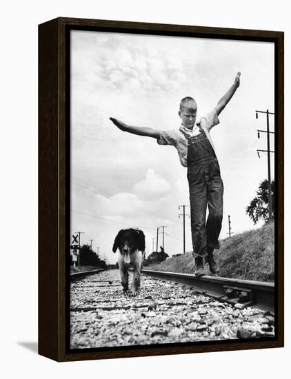 Larry Jim Holm with Dunk, His Spaniel Collie Mix, Walking Rail of Railroad Tracks in Rural Area-Myron Davis-Framed Premier Image Canvas