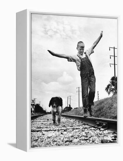 Larry Jim Holm with Dunk, His Spaniel Collie Mix, Walking Rail of Railroad Tracks in Rural Area-Myron Davis-Framed Premier Image Canvas