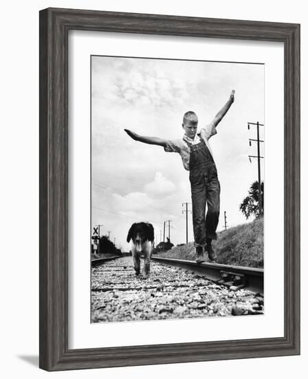 Larry Jim Holm with Dunk, His Spaniel Collie Mix, Walking Rail of Railroad Tracks in Rural Area-Myron Davis-Framed Photographic Print