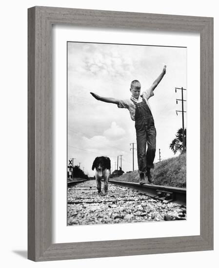 Larry Jim Holm with Dunk, His Spaniel Collie Mix, Walking Rail of Railroad Tracks in Rural Area-Myron Davis-Framed Photographic Print