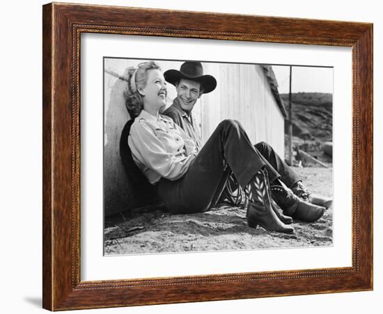 Laughing Couple in Western Attire Sitting on the Ground-null-Framed Photo