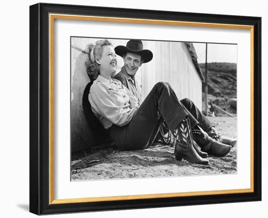 Laughing Couple in Western Attire Sitting on the Ground-null-Framed Photo