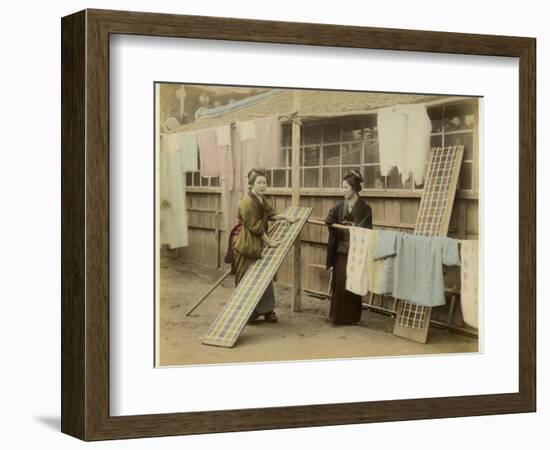 Laundry Day in Japan: Two Women Hang Up Clothes and Fabric to Dry Outdoors-null-Framed Photographic Print