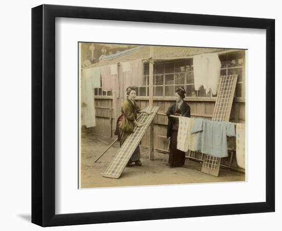 Laundry Day in Japan: Two Women Hang Up Clothes and Fabric to Dry Outdoors-null-Framed Photographic Print