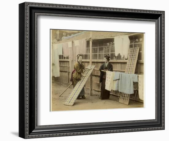 Laundry Day in Japan: Two Women Hang Up Clothes and Fabric to Dry Outdoors-null-Framed Photographic Print