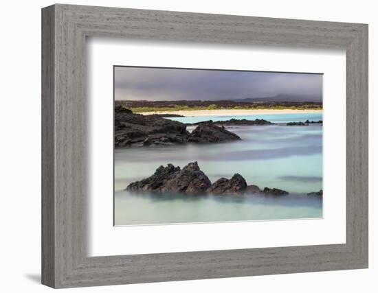 Lava rocks along tranquil shoreline of San Cristobal Island, Galapagos, Ecuador.-Adam Jones-Framed Photographic Print