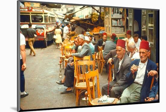 Lebanese Gentlemen sits at a steetside cafe sipping tea and smoking traditional narghile pipes-Carlo Bavagnoli-Mounted Photographic Print
