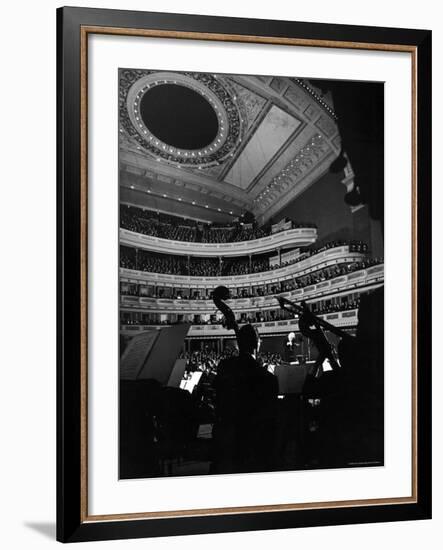 Leopold Stokowski Conducting the New York Philharmonic Orchestra in Performance at Carnegie Hall-Gjon Mili-Framed Premium Photographic Print