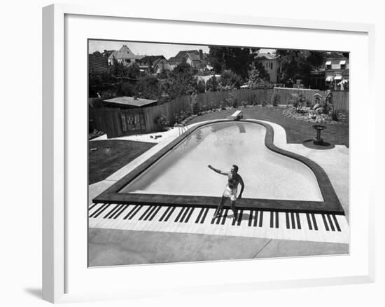 Liberace at the 'Piano' Shaped Pool in His Home-Loomis Dean-Framed Premium Photographic Print