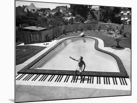 Liberace at the 'Piano' Shaped Pool in His Home-Loomis Dean-Mounted Premium Photographic Print