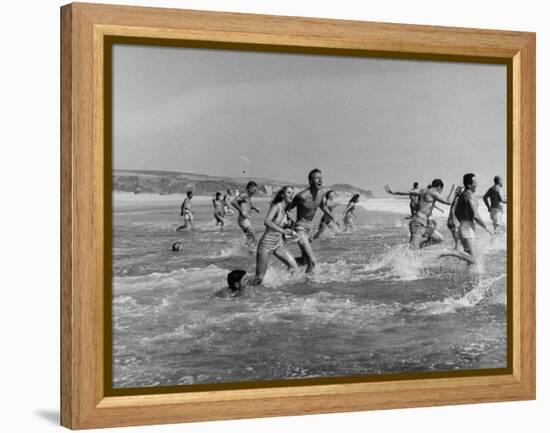 Lifeguards and Members of Womens Swimming Team Start Day by Charging into Surf-Peter Stackpole-Framed Premier Image Canvas