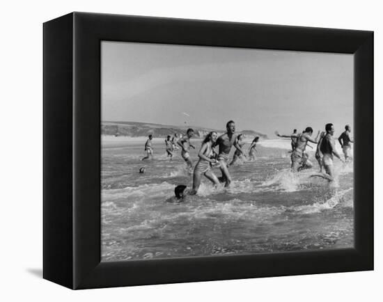 Lifeguards and Members of Womens Swimming Team Start Day by Charging into Surf-Peter Stackpole-Framed Premier Image Canvas