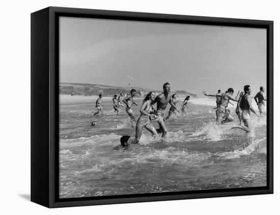 Lifeguards and Members of Womens Swimming Team Start Day by Charging into Surf-Peter Stackpole-Framed Premier Image Canvas