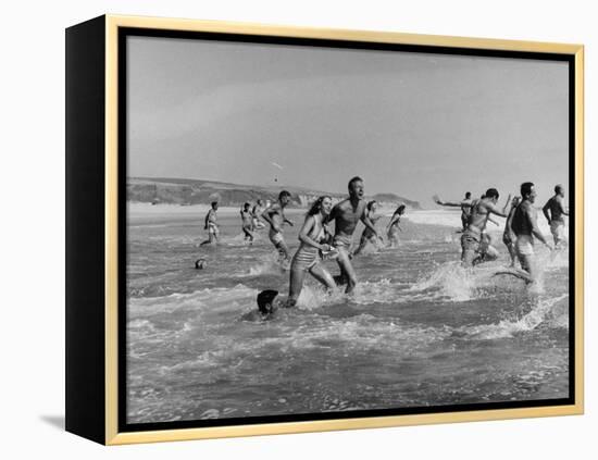 Lifeguards and Members of Womens Swimming Team Start Day by Charging into Surf-Peter Stackpole-Framed Premier Image Canvas