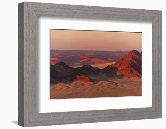 Light illuminates the Naukluft Mountains and Namib Desert at sunrise. Namibia.-Sergio Pitamitz-Framed Photographic Print