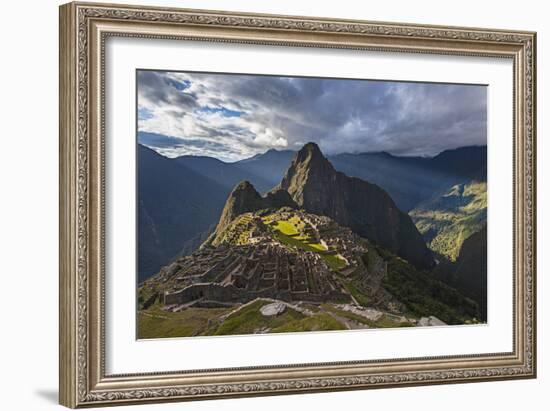 Light Streams Through The Clouds And Lights Parts Of The Ancient City Of Machu Picchu-Joe Azure-Framed Photographic Print