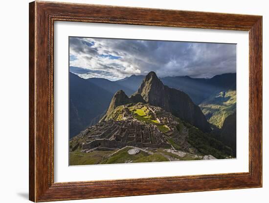 Light Streams Through The Clouds And Lights Parts Of The Ancient City Of Machu Picchu-Joe Azure-Framed Photographic Print