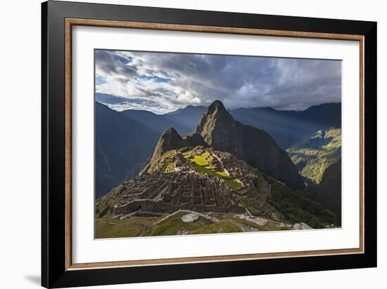 Light Streams Through The Clouds And Lights Parts Of The Ancient City Of Machu Picchu-Joe Azure-Framed Photographic Print