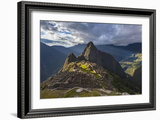 Light Streams Through The Clouds And Lights Parts Of The Ancient City Of Machu Picchu-Joe Azure-Framed Photographic Print