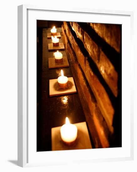 Lighted Candles and Brick Wall-Michele Molinari-Framed Photographic Print