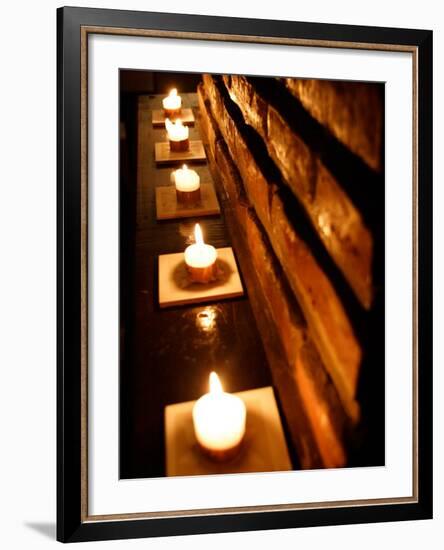 Lighted Candles and Brick Wall-Michele Molinari-Framed Photographic Print