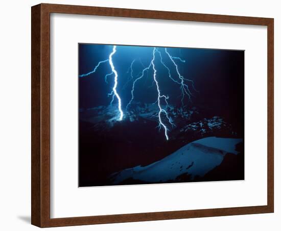 Lightning During a Storm over Snowy Mountains-null-Framed Photo