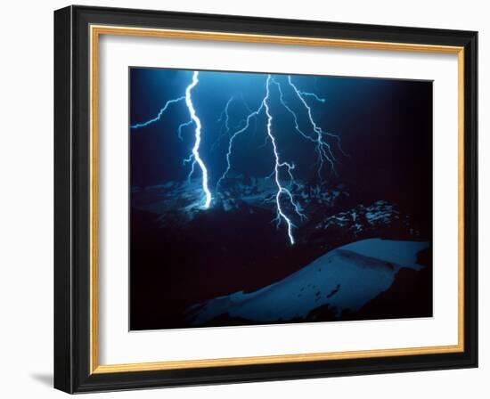 Lightning During a Storm over Snowy Mountains-null-Framed Photo