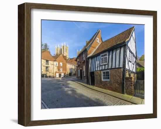 Lincoln Cathedral and timbered architecture viewed from the cobbled Steep Hill, Lincoln, Lincolnshi-Frank Fell-Framed Photographic Print