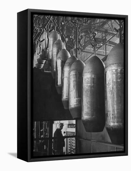 Line of 500 lbs Bombs Jiggling Along on Overhead Conveyor Hooks Abover Worker-Andreas Feininger-Framed Premier Image Canvas