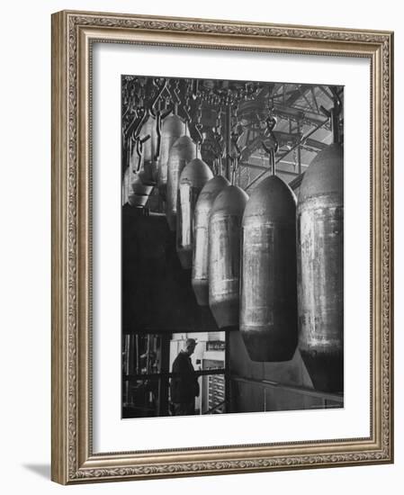 Line of 500 lbs Bombs Jiggling Along on Overhead Conveyor Hooks Abover Worker-Andreas Feininger-Framed Photographic Print