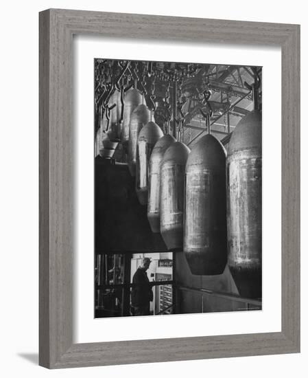 Line of 500 lbs Bombs Jiggling Along on Overhead Conveyor Hooks Abover Worker-Andreas Feininger-Framed Photographic Print