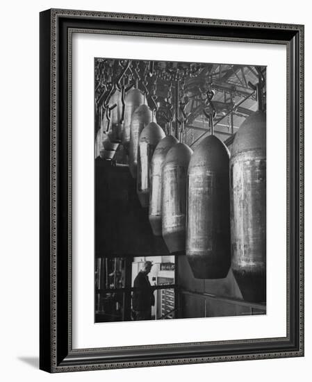 Line of 500 lbs Bombs Jiggling Along on Overhead Conveyor Hooks Abover Worker-Andreas Feininger-Framed Photographic Print