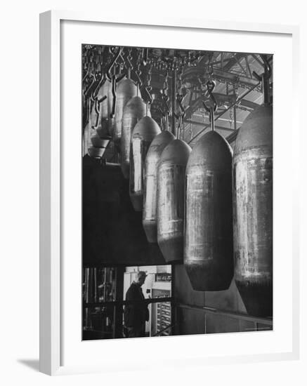 Line of 500 lbs Bombs Jiggling Along on Overhead Conveyor Hooks Abover Worker-Andreas Feininger-Framed Photographic Print