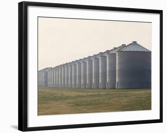 Line of Storage Bins for Corn, Unidentified Section of the Mid-West-John Zimmerman-Framed Photographic Print