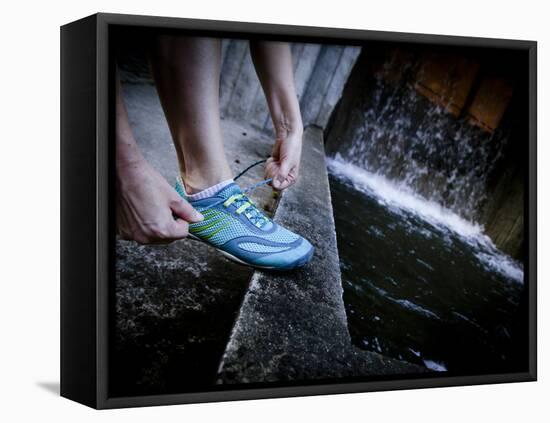 Lisa Eaton Laces Up Her Running Shoe Near a Water Feature at Freeway Park - Seattle, Washington-Dan Holz-Framed Premier Image Canvas