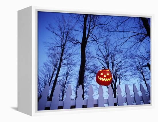 Lit Jack o'-Lantern Perched on Picket Fence-Ralph Morsch-Framed Premier Image Canvas