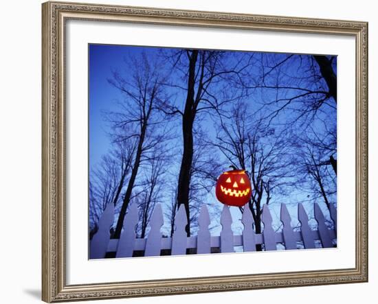 Lit Jack o'-Lantern Perched on Picket Fence-Ralph Morsch-Framed Photographic Print