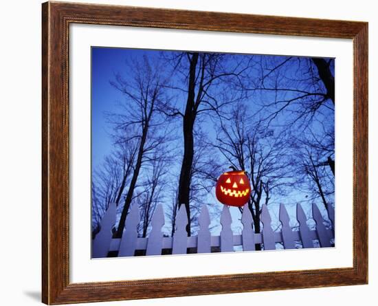 Lit Jack o'-Lantern Perched on Picket Fence-Ralph Morsch-Framed Photographic Print