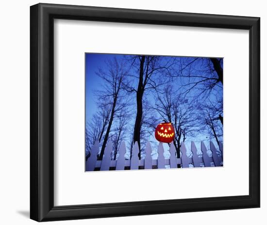 Lit Jack o'-Lantern Perched on Picket Fence-Ralph Morsch-Framed Photographic Print