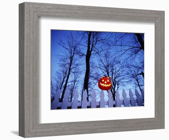 Lit Jack o'-Lantern Perched on Picket Fence-Ralph Morsch-Framed Photographic Print