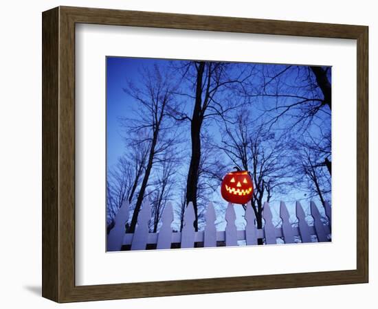 Lit Jack o'-Lantern Perched on Picket Fence-Ralph Morsch-Framed Photographic Print