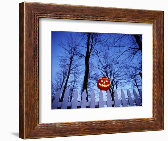 Lit Jack o'-Lantern Perched on Picket Fence-Ralph Morsch-Framed Photographic Print