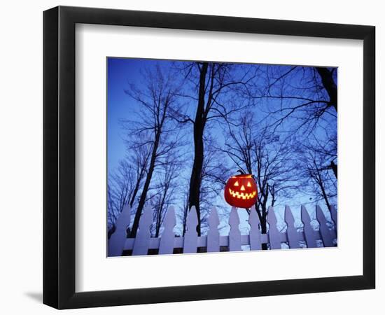 Lit Jack o'-Lantern Perched on Picket Fence-Ralph Morsch-Framed Photographic Print