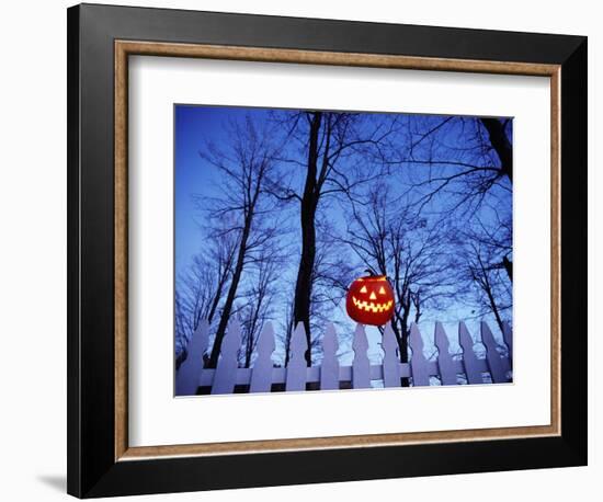 Lit Jack o'-Lantern Perched on Picket Fence-Ralph Morsch-Framed Photographic Print