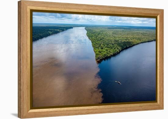 Little boat on the meeting point of the Casiquiare River and black Pasimoni River-Michael Runkel-Framed Premier Image Canvas